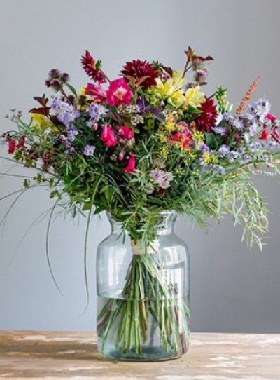 Mixed Vase Bouquet - Bright, mixed colour tied bouquet.

A hand-tied bouquet of mixed coloured seasonal flowers with a variety of foliages, presented in a glass vase. Always including the freshest flowers of the season, for example roses, lisianthus, chrysanthemums, carnations, lilies, delphinium, leucadendron, gypsophila, eucalyptus, ruscus and grasses. We will choose a vase style to suit your bouquet, which is often made from eco friendly recycled glass, and will tie your flowers with natural raffia or twine. Your florist will hand make your bouquet spiralling the stems and tying them so they need no further arranging by the recipient. Always colourful, always cheerful, natural and nostalgic. Flower varieties may vary from those shown but will be selected from the best of the growing season. Ideal for a thank you or birthday gift, to say "hello" or "happy new home".