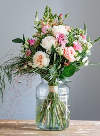 Pink Vase Bouquet - Glass vase full of pink and cream shaded flowers.

A hand-tied bouquet of mixed seasonal flowers in shades of soft pink and cream with a variety of foliages, presented in a glass vase. Always including the freshest flowers of the season, for example roses, lizianthus, lilies, snap dragons, veronica or lysmachia, gypsophila, eucalyptus, ruscus and grasses. We will choose a vase style to suit your tied bouquet, often made from eco-friendly recycled glass, and using natural raffia or twine to tie the stems. Your florist will hand make your bouquet, spiralling the stems and tying them so that the flowers need no further arranging by the recipient. Always beautiful, always elegant, subtle and romantic. Flower varieties may vary from those shown but will be selected from the best of the growing season. Ideal for a birthday or anniversary treat, to say thank you or I love you.
